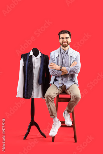 Male tailor with mannequin ...