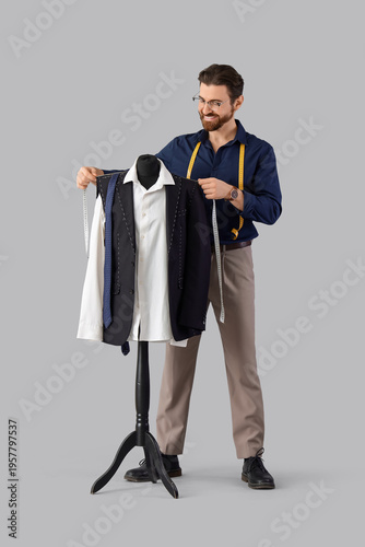 Male tailor measuring cloth...