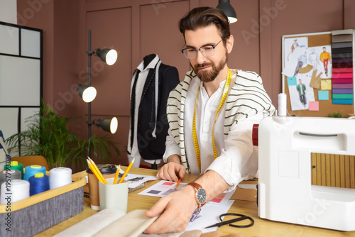 Male tailor with fabric sam...