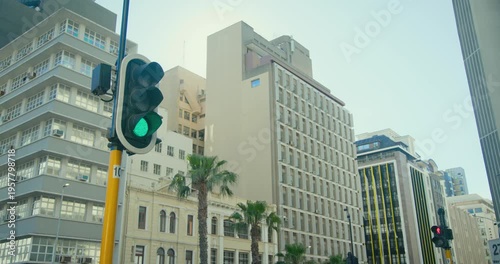 Fixed downtown camera is starting to record as traffic signal is showing green to control vehicles