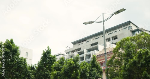 Gimbal is starting camera pan left, shifting lamp and flats, centering clock tower above treeline