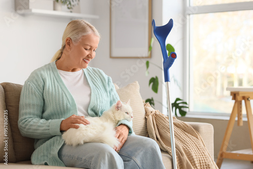 Mature woman with crutch an...