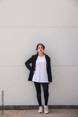 Realistic T-Shirt Mockup on Model in Black Jacket Minimal Urban Background