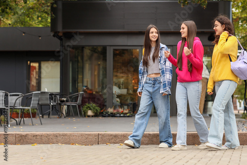 Happy teenage girls walking...