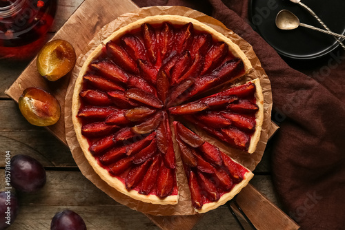 Board with tasty plum pie o...