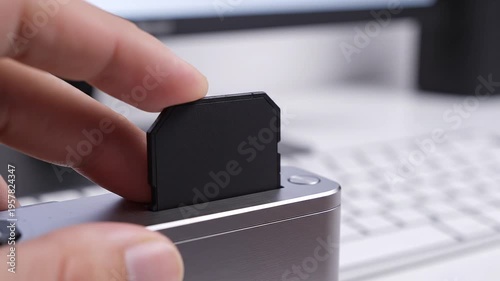 Inserting secure digital card into reader closeup technology concept