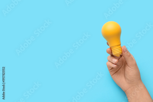Female hand with yellow lig...