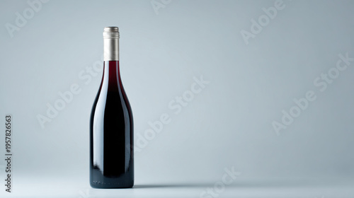 Wallpaper Mural Slender red wine bottle with long neck standing on neutral grey studio background, elegant reflection and soft lighting conveying refined mood Torontodigital.ca