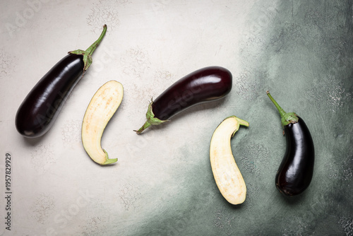 Fresh eggplants on green gr...