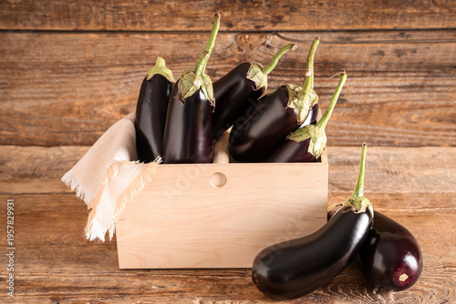 Box with fresh eggplants on...