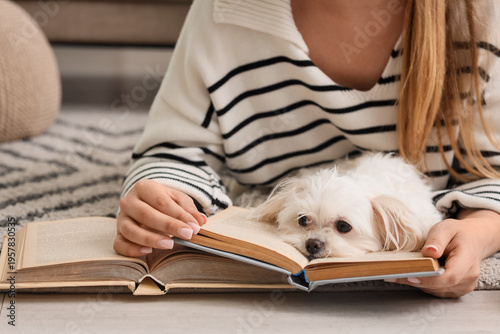 Young woman reading book wi...