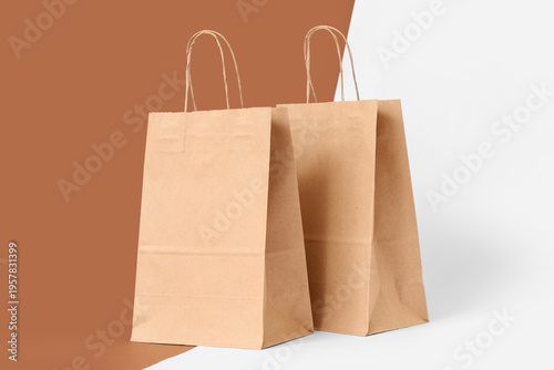Paper bags on color background