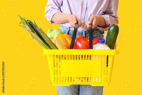 Woman holding shopping bask...