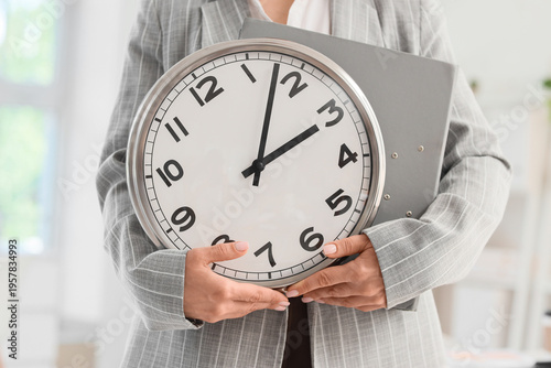 Businesswoman with clock an...