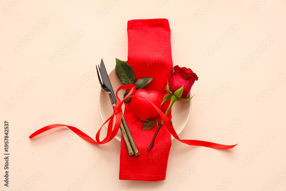 Obraz premium Beautiful table setting with red rose and heart on beige background. Valentine's Day celebration