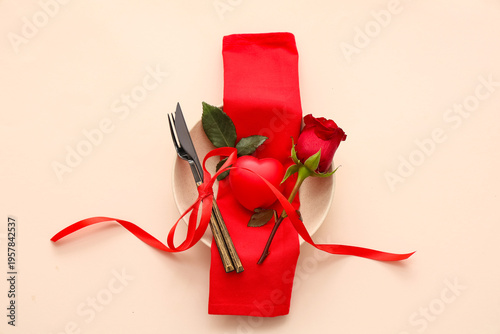 Beautiful table setting with red rose and heart on beige background. Valentine's Day celebration