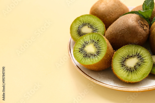 Plate with fresh kiwi and m...