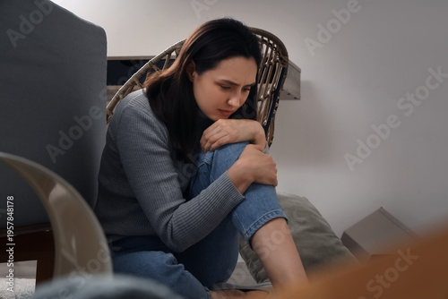 Depressed young woman sitti...