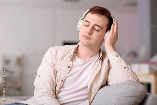 Young man listening audiobo...