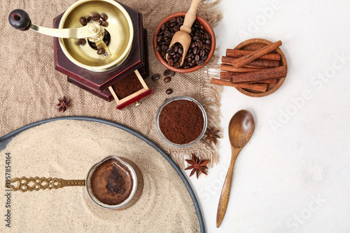 Pot of hot coffee in sand, ...