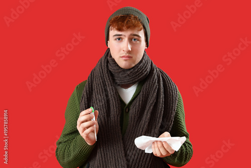 Ill young man with tissue a...
