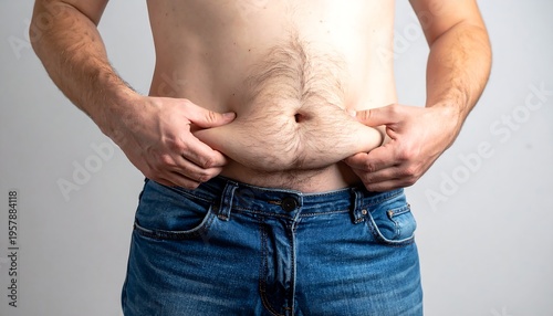 Wallpaper Mural Man pinching excess belly fat in jeans. Torontodigital.ca