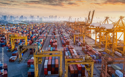 Logistics and transportation of Container Cargo ship and Cargo plane with working crane bridge in shipyard at sunrise, logistic import export and transport industry background