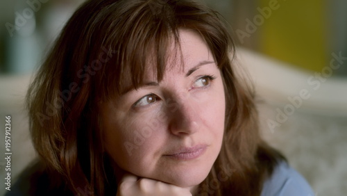 Fotografie Thoughtful woman looking away with natural expression indoors, have fun and enjo