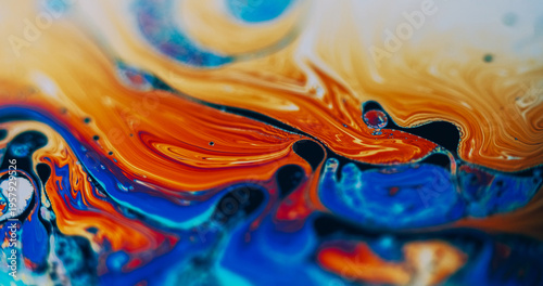 Psychedelic texture. Fuel spill. Blur orange blue purple color oil ink round bubbles pollution mix wave water on abstract background.