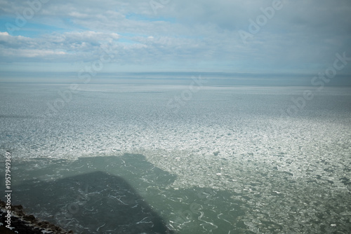 Frozen Sea and Ice Floes Under a Cloudy Winter Sky on the Distant Horizon