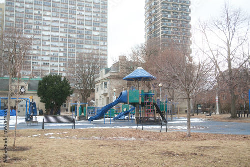 Empty Urban Playground With Blue Slides and Benches in Winter Near Apartment Towers