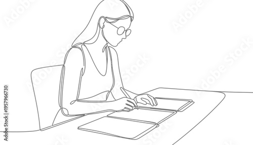 A woman working on a digital tablet with a stylus in a minimalist office setting