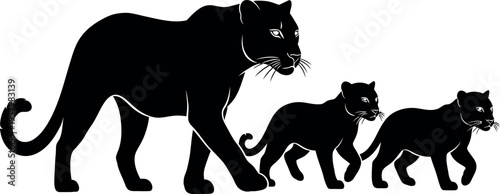Silhouette of a large cat and two smaller cats walking together in a line