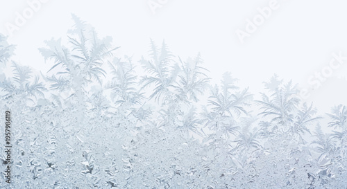 frosty window with ice crystals on glass in winter