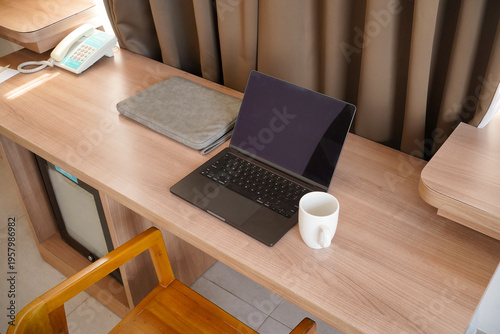 Minimal Laptop Workspace with Coffee Mug and Sleeve on Wooden Desk