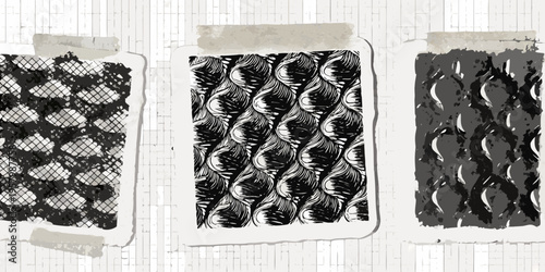 Three patterned paper swatches taped to a white woodgrain surface