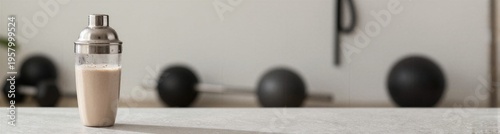Protein shake prepared near gym equipment on countertop