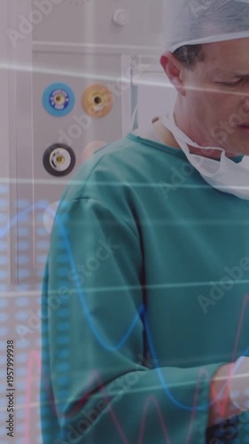 Vertical video: Surgeon adjusting device, gloved hands activating HUD charts by outlets for surgery