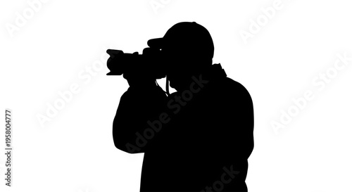 Silhouette of a photographer holding a professional camera capturing an image.
