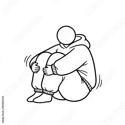 Person huddled in a hoodie with knees to chest.