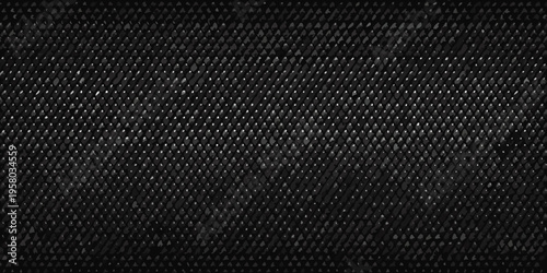 Close up of a dark textured woven material resembling carbon fiber