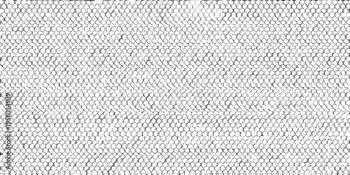 Close up of a textured woven rug with a repeating pattern