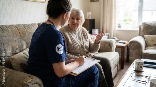 Caring Nurse Discussing Health With Elderly Woman At Home