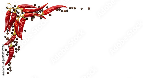 A decorative corner arrangement of dried red chili peppers and black peppercorns on a white background.
