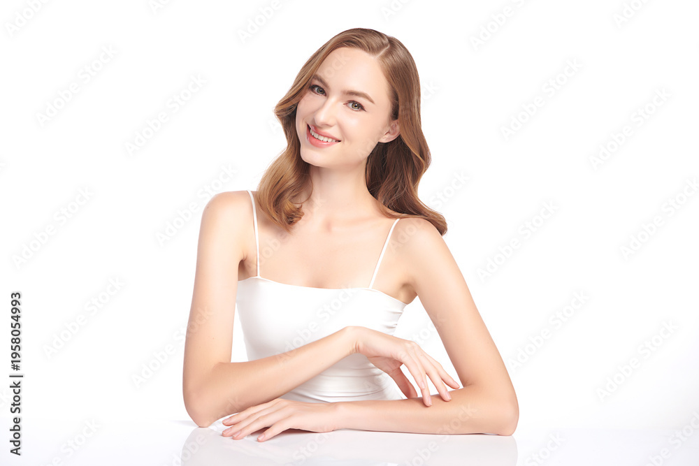Fototapeta premium A beautiful young woman with clean, fresh skin against a white background. Skincare, facial treatment, cosmetology, beauty, and spa. An elegant portrait of an woman.