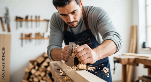 Carpenter using hand plane on wood beam in workshop. Craftsman finishing timber plank for furniture construction. Skilled male manual worker shaping piece during carpentry project activity.