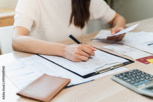 Fotografie person using calculator calculating tax refund on the table