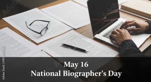 Professional writer working on biography at desk with laptop and papers