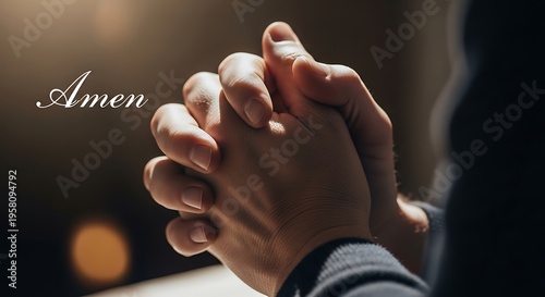 Close up of hands clasped in prayer with a soft warm light and text amen