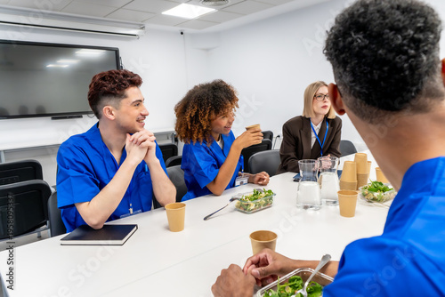 Multicultural medical students having lunch break meeting